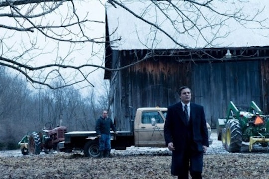 A still from the movie Dark Waters. A man walks in a field against an Appalachian backdrop.
