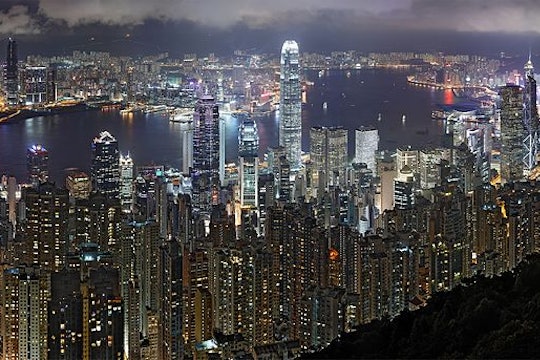 Hong Kong Night Skyline The skyline of Hong Kong, as seen at night. Many tall skyscrapers glow with artificial light.