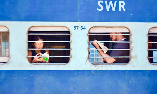 two people through the windows of a blue train
