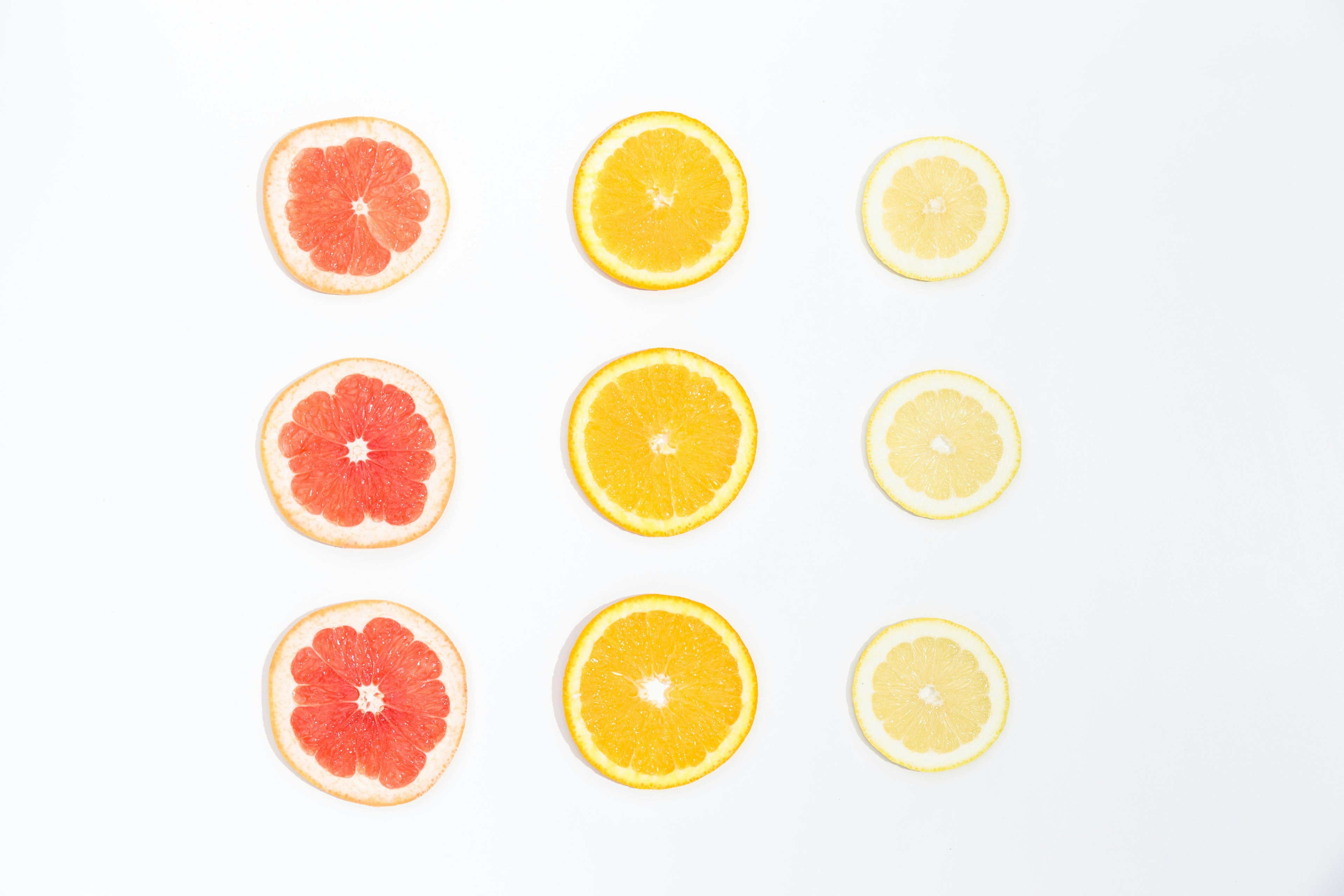 nine slices of citrus fruits arranged in rows against a white background