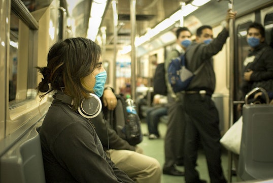 people on a train wearing flu masks