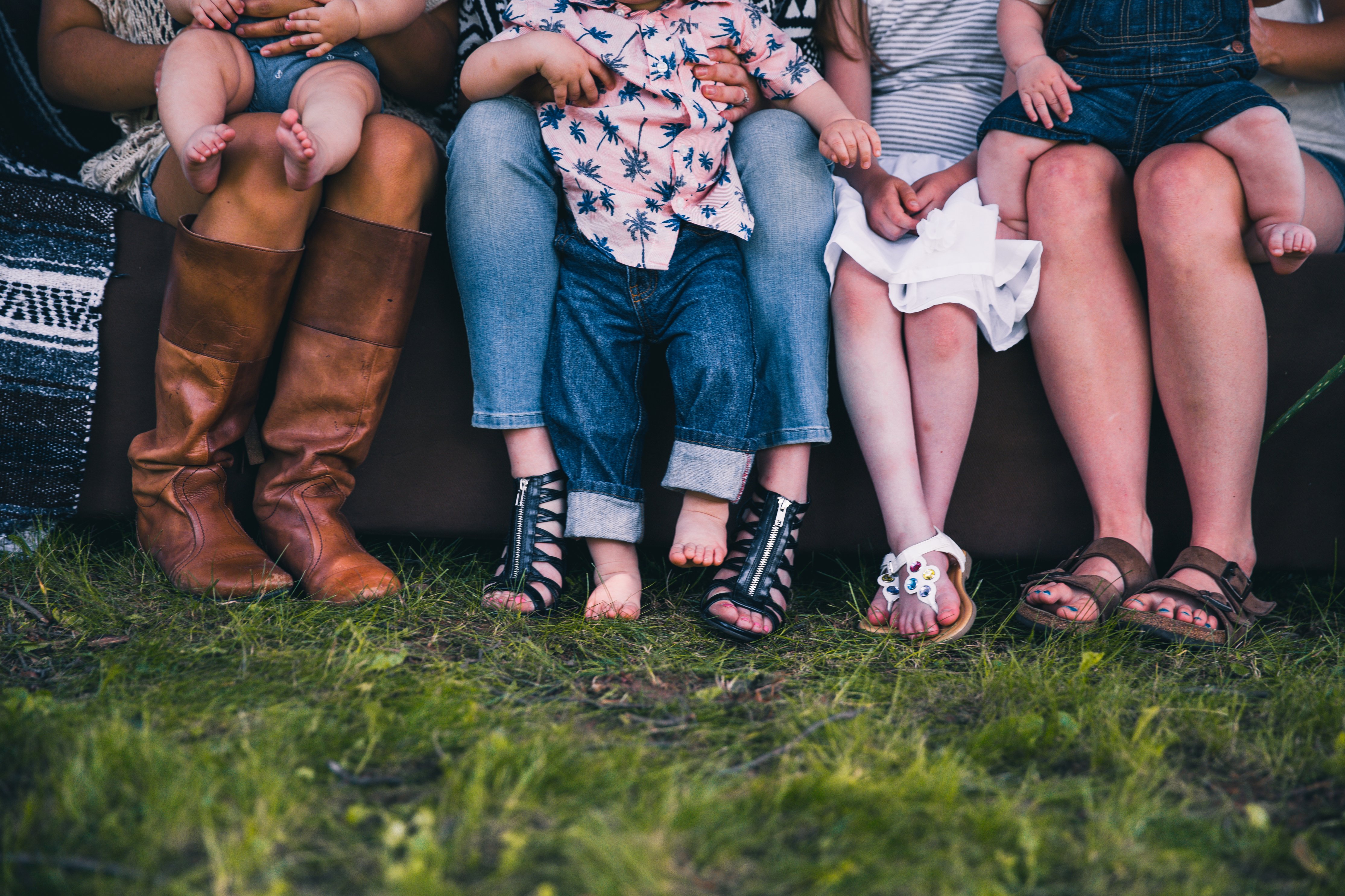 diverse family people feet sitting grass