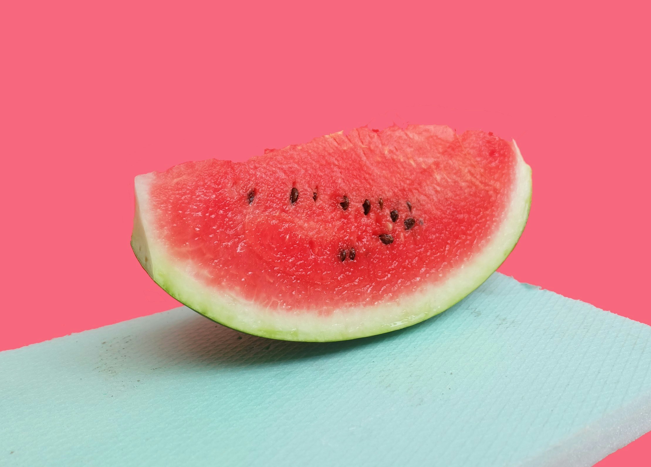 watermelon against pink and blue background