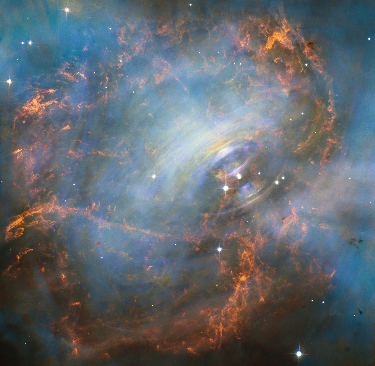 The pulsar at the center of the Crab Nebula, emitting wisps of high energy particles by the spinning of the star.