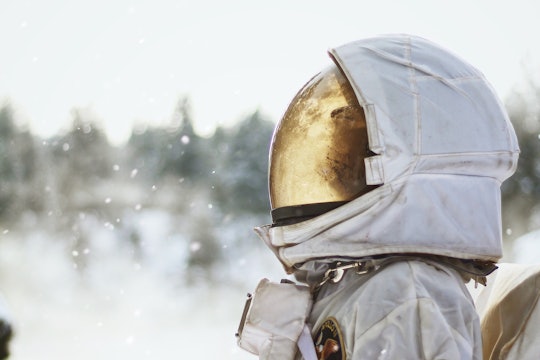 A person in a space suit in a snowy field A person in a space suit in a snowy field