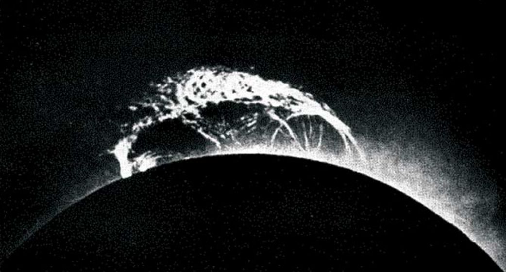 A solar prominence over the sun during the 1919 solar eclipse.