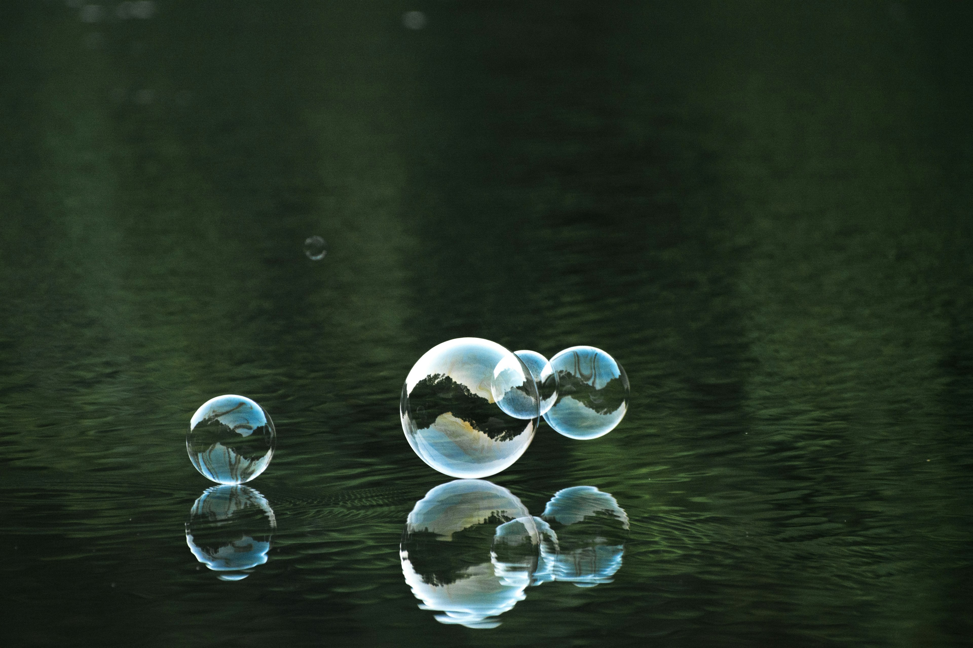 three bubbles floating over water