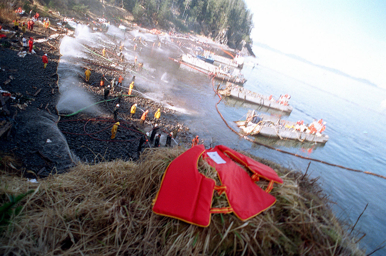  U.S. Navy Mechanized Landing Craft (LCMs) are anchored along the shoreline as Navy and civilian personnel position hoses during oil clean-up efforts on Smith island. The massive oil spill occurred when the commercial tanker Exxon Valdez ran aground while transiting the waters of Prince William Sound on March 24th.