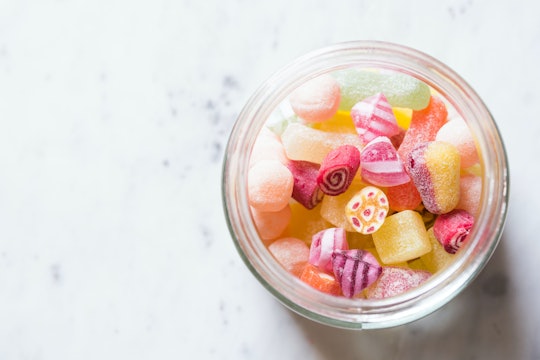 Assorted sugary candies in a glass jar