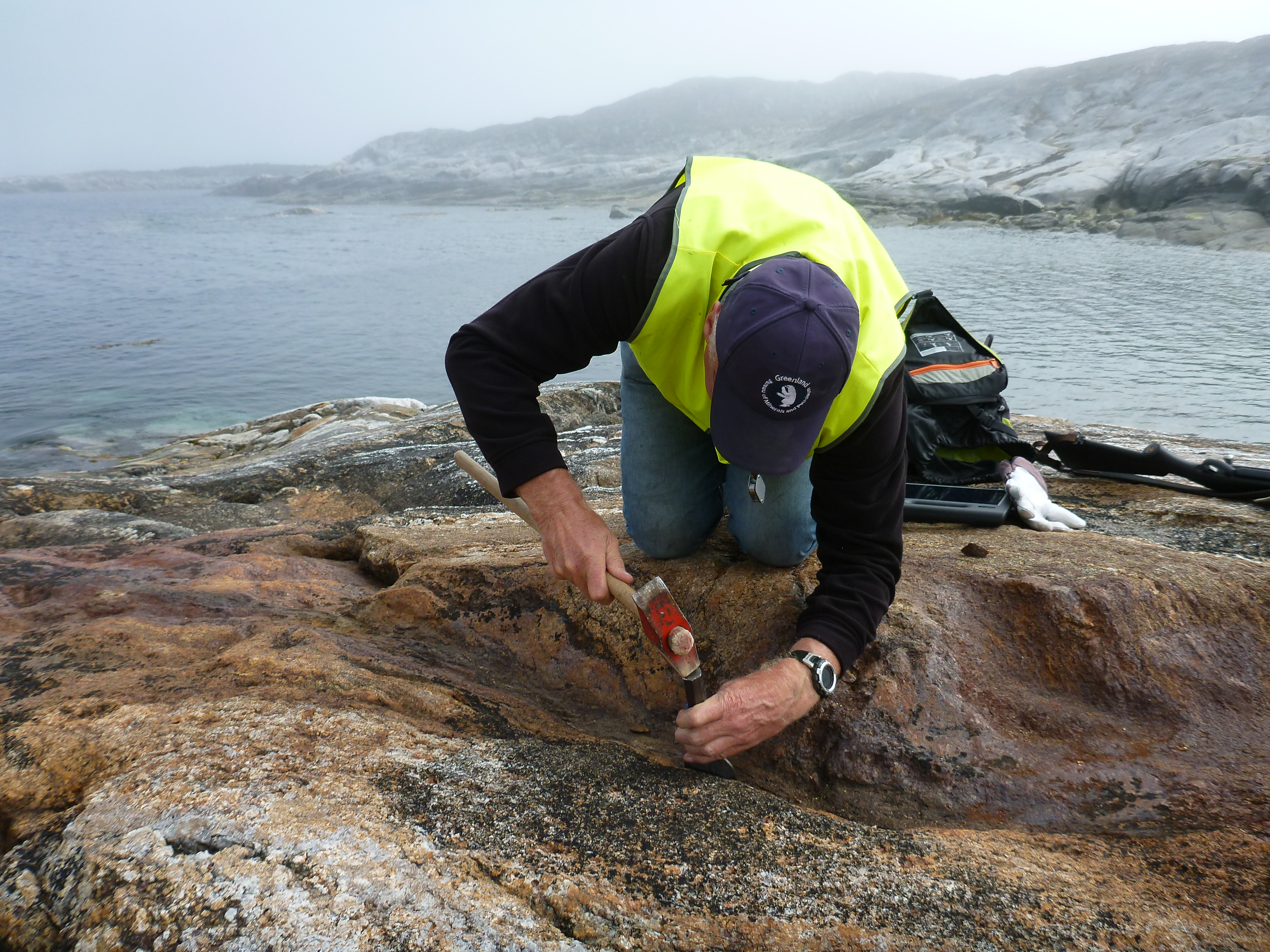 A Government of Greenland geologist collects a sample for analysis.