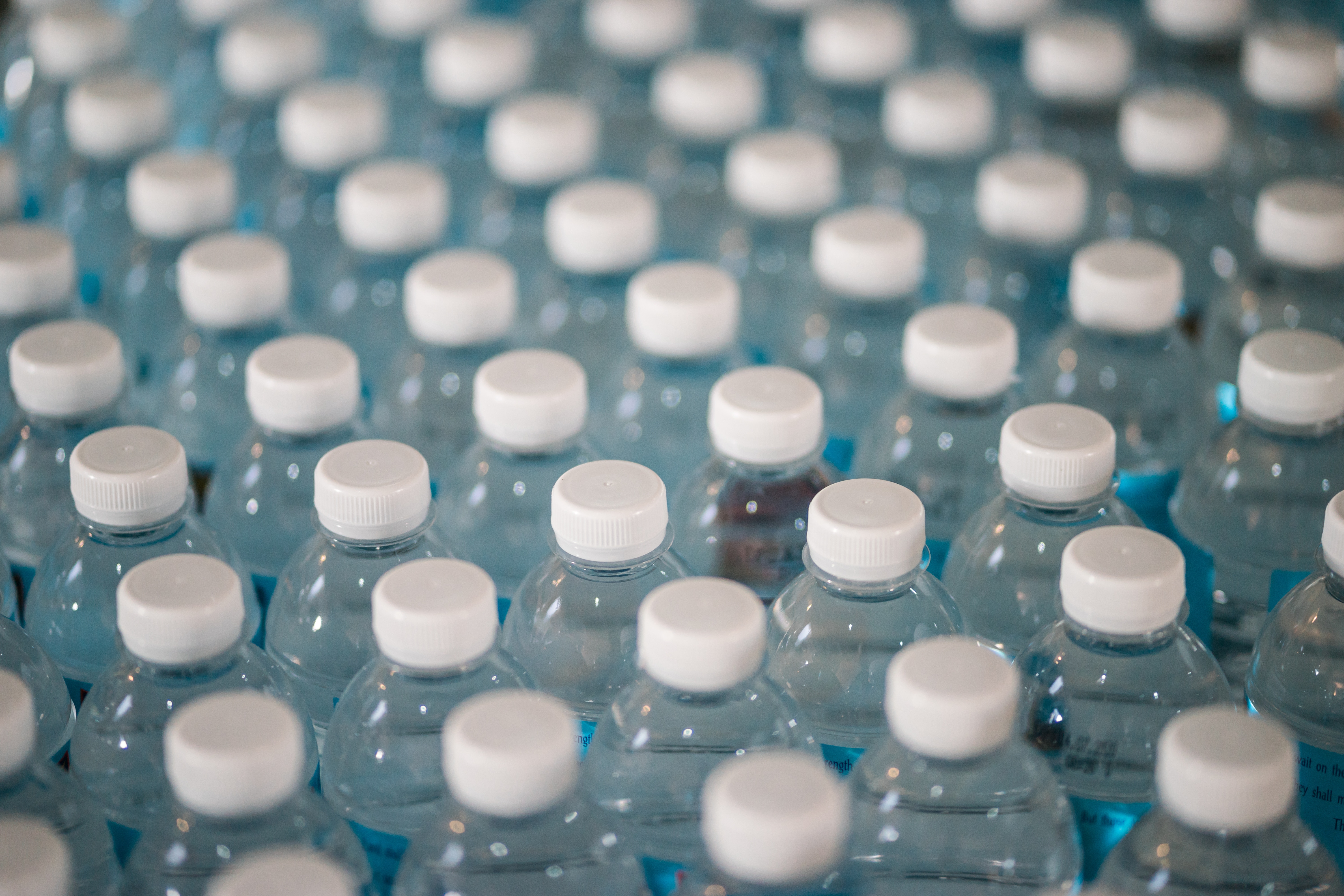 tops of many plastic water bottles