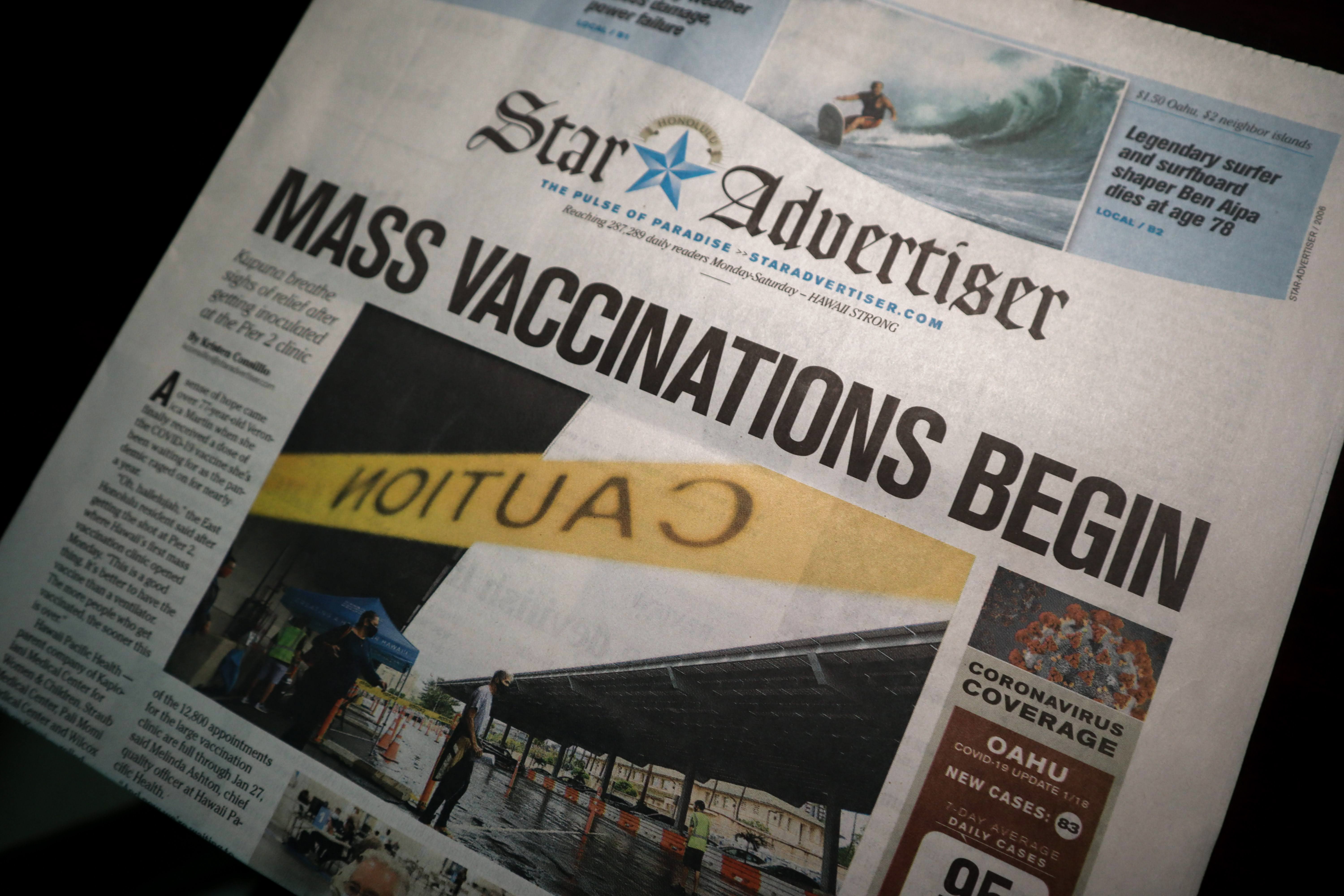A newspaper article with the headline "mass vaccinations begin"