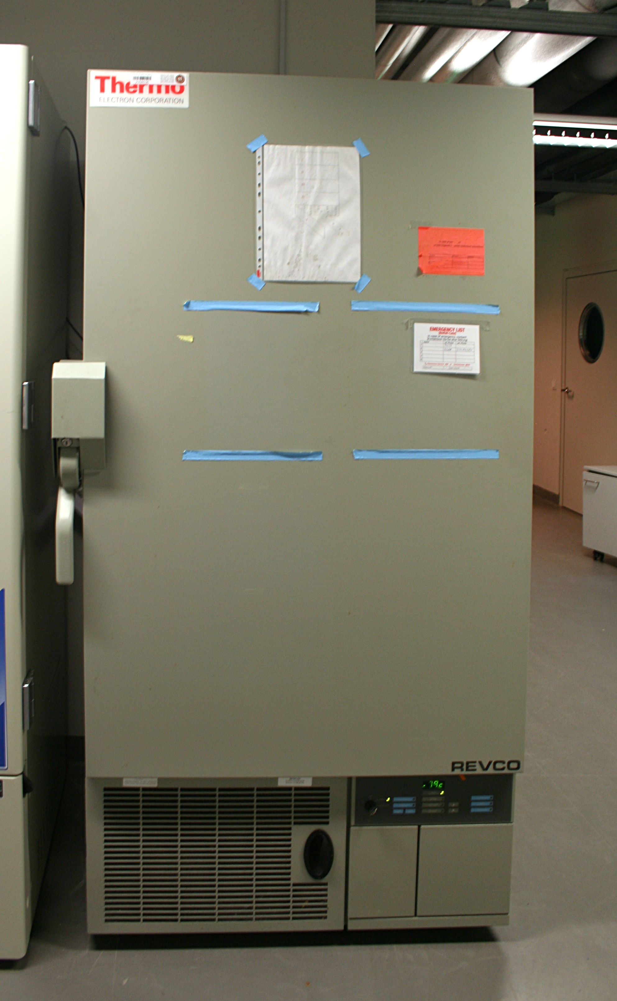 A common ultracold freezer found in a lab. It stands upright, with a temperature readout on the bottom