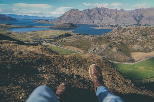 person's feet and mountains in the background