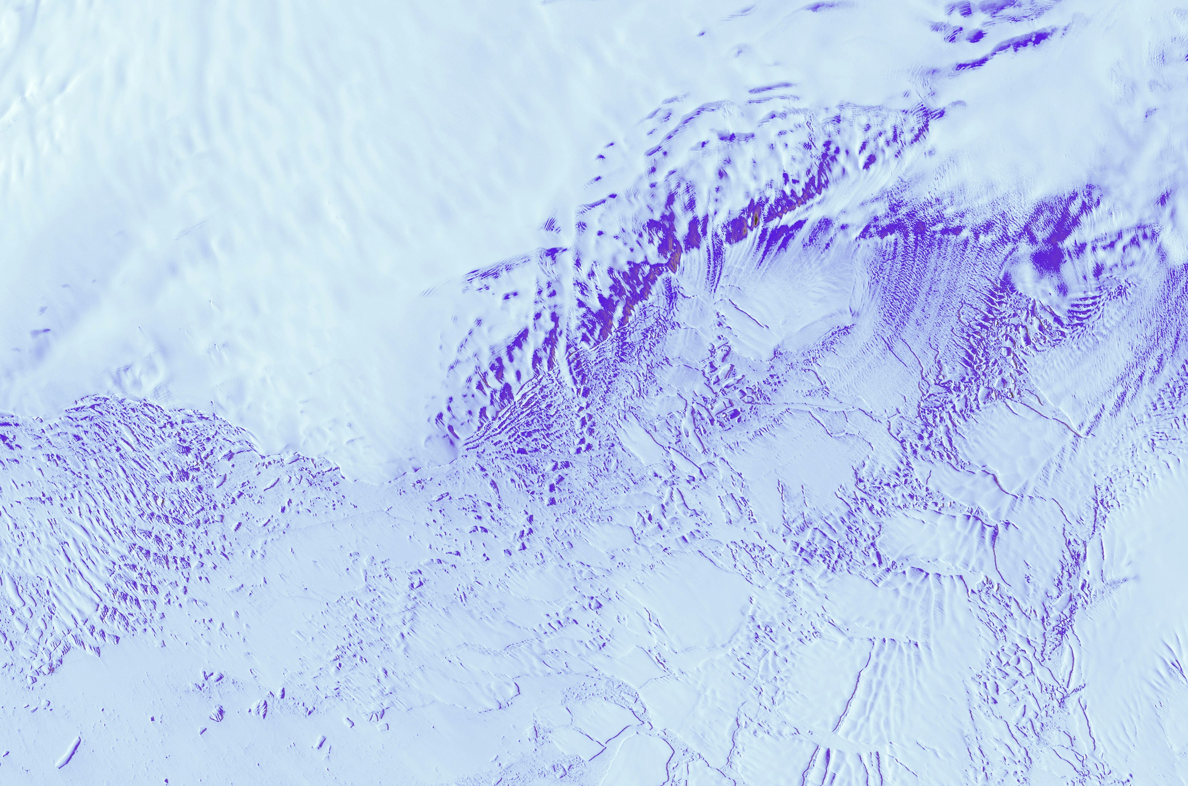 a close up of ice marked with dark blue swirls