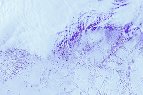 a close up of ice marked with dark blue swirls
