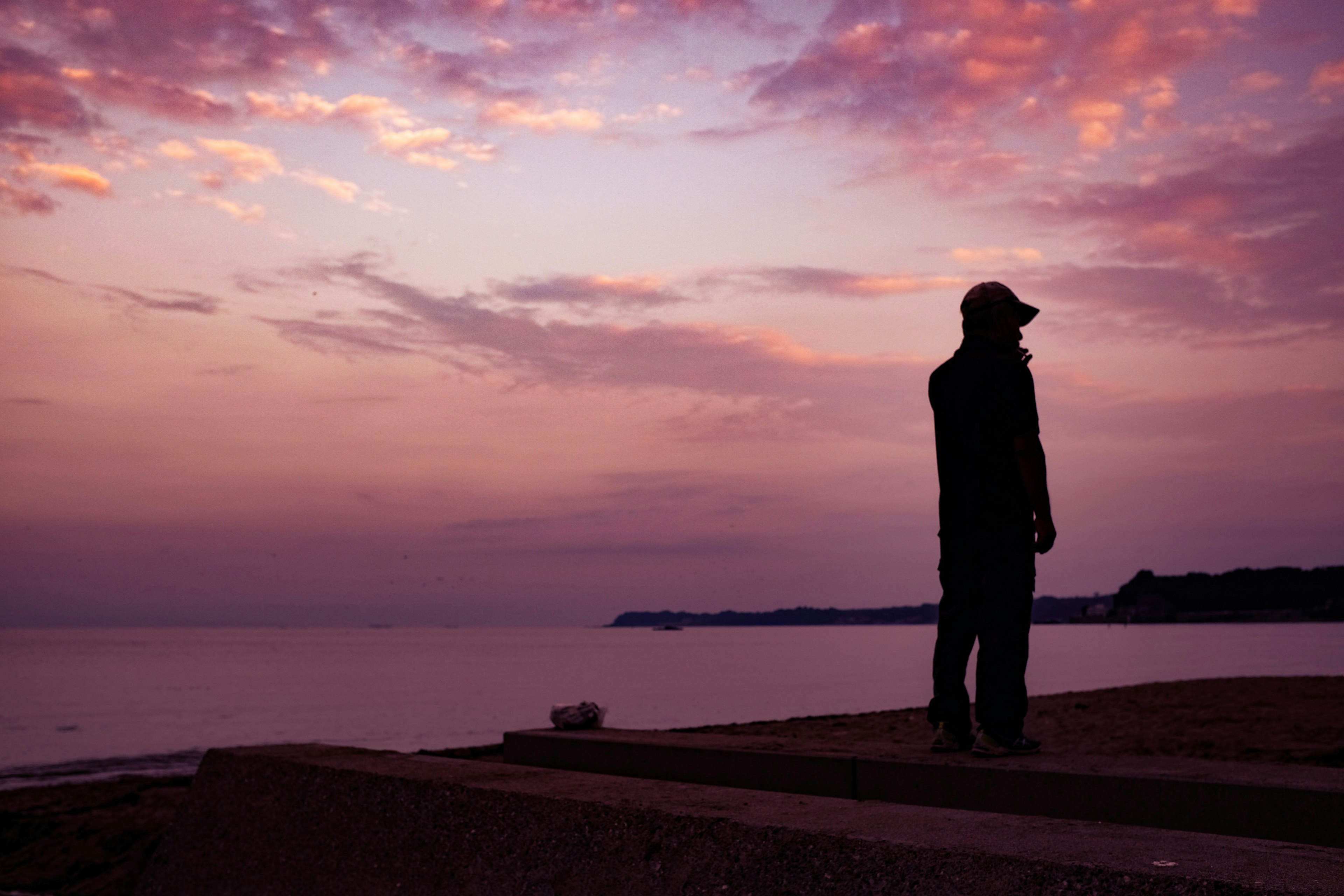 a man standing outside in the sunset