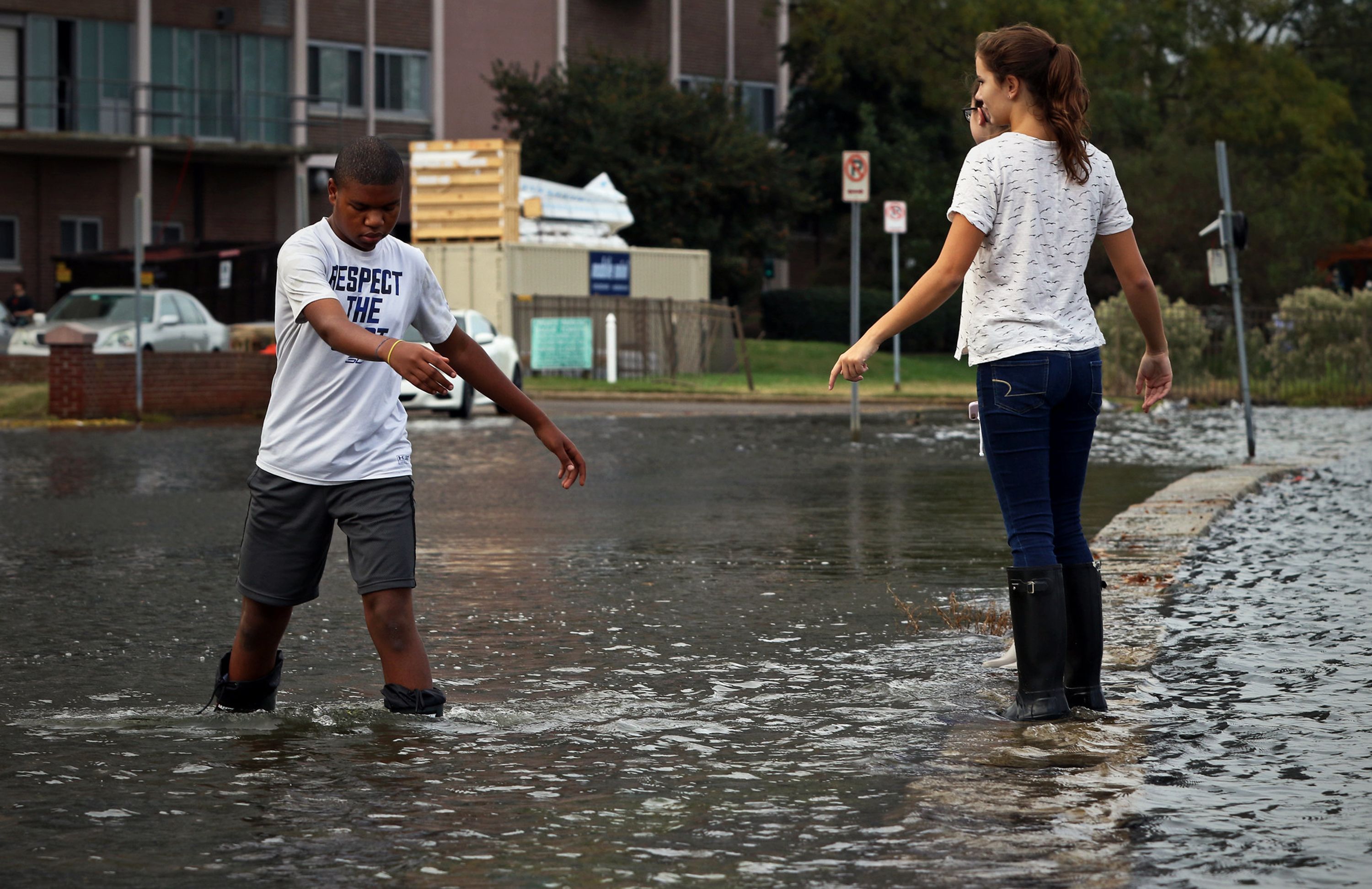 Children in Norfolk, Virginia, record the "king tide" after a flood in 2019