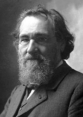 A black and white portrait photograph of Russian Nobel Prize-winning scientist, Ilya Metchnikoff. He is wearing a beard and glasses; long, messy hair; and a suit jacket.