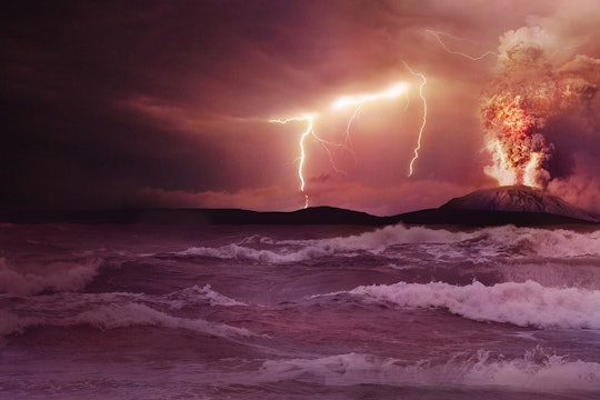 early Earth lighting and an erupting volcano over the ocean