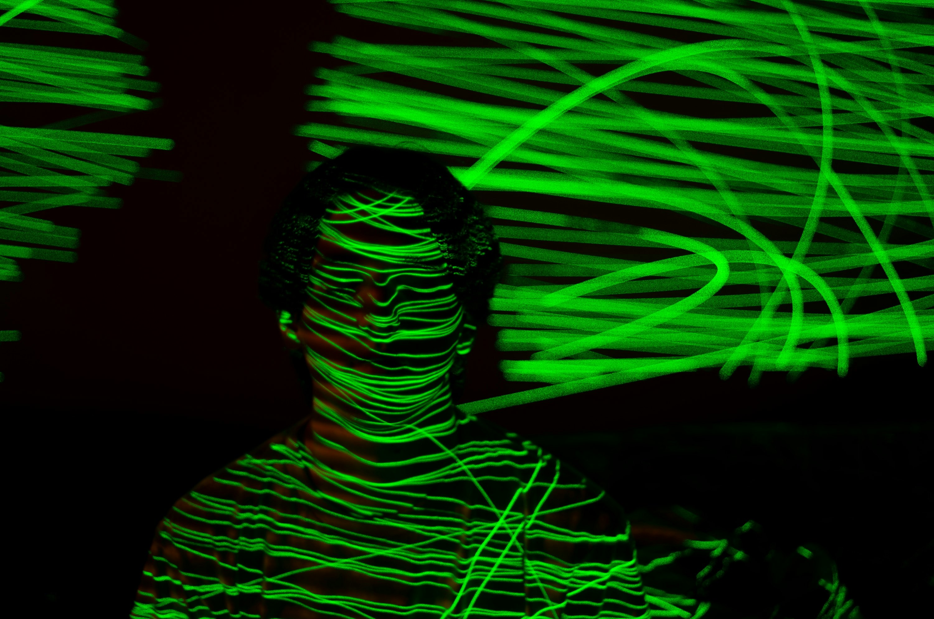 a person covered with green laser-like lights