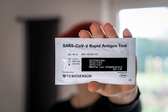 A person holding a rapid antigen COVID-19 coronavirus test