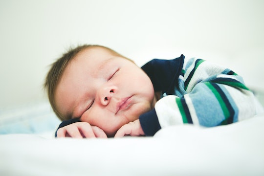 a sleeping baby sleeping baby in a striped shirt