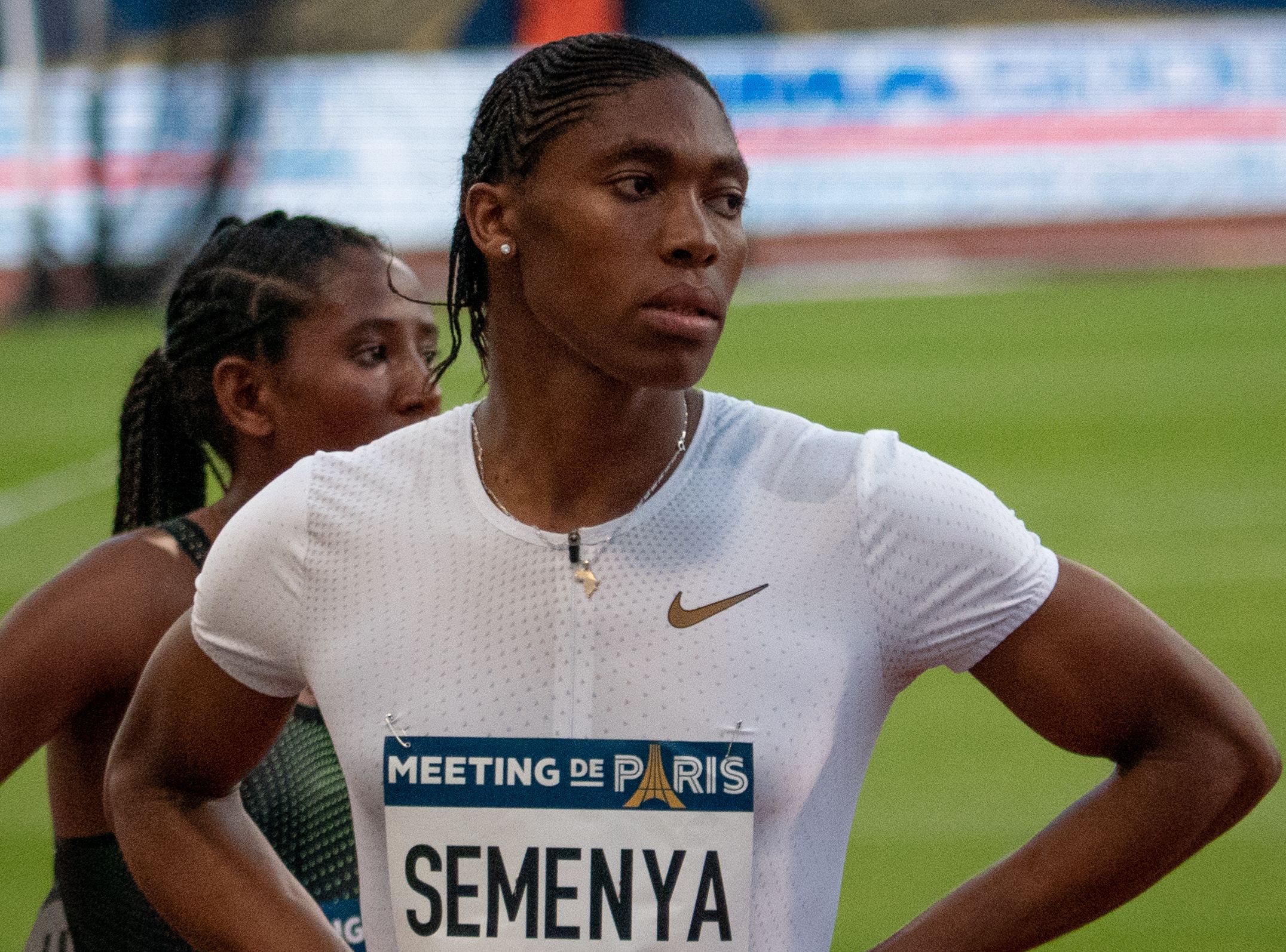 A picture of Caster Semenya after a race in Paris, standing with hands on her hips.