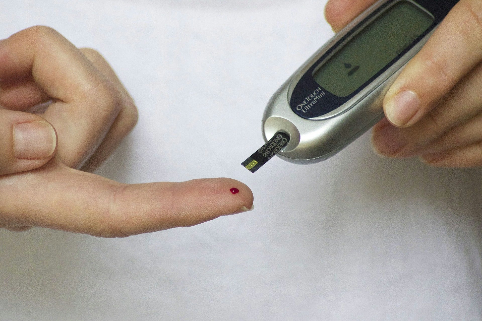 A diabetic pricking their finger for a blood test